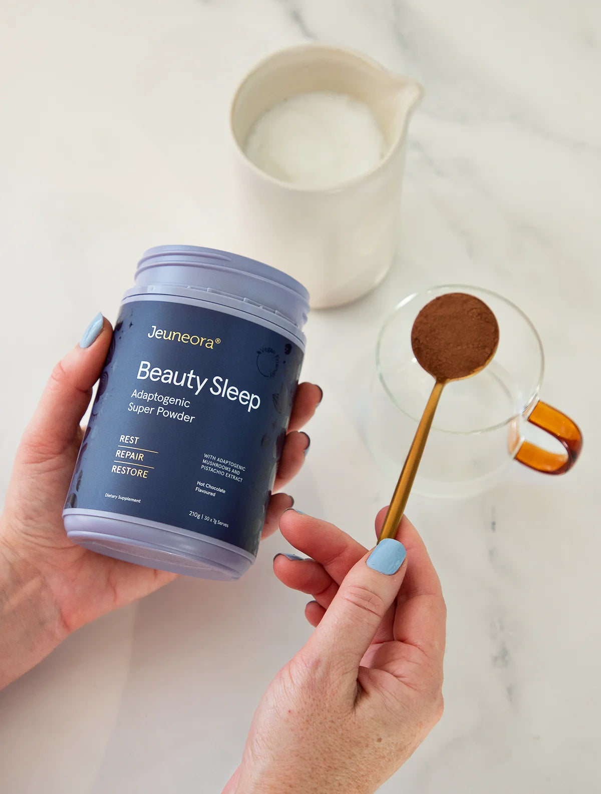 hand holding Jeueneora beauty sleep adaptogenic powder