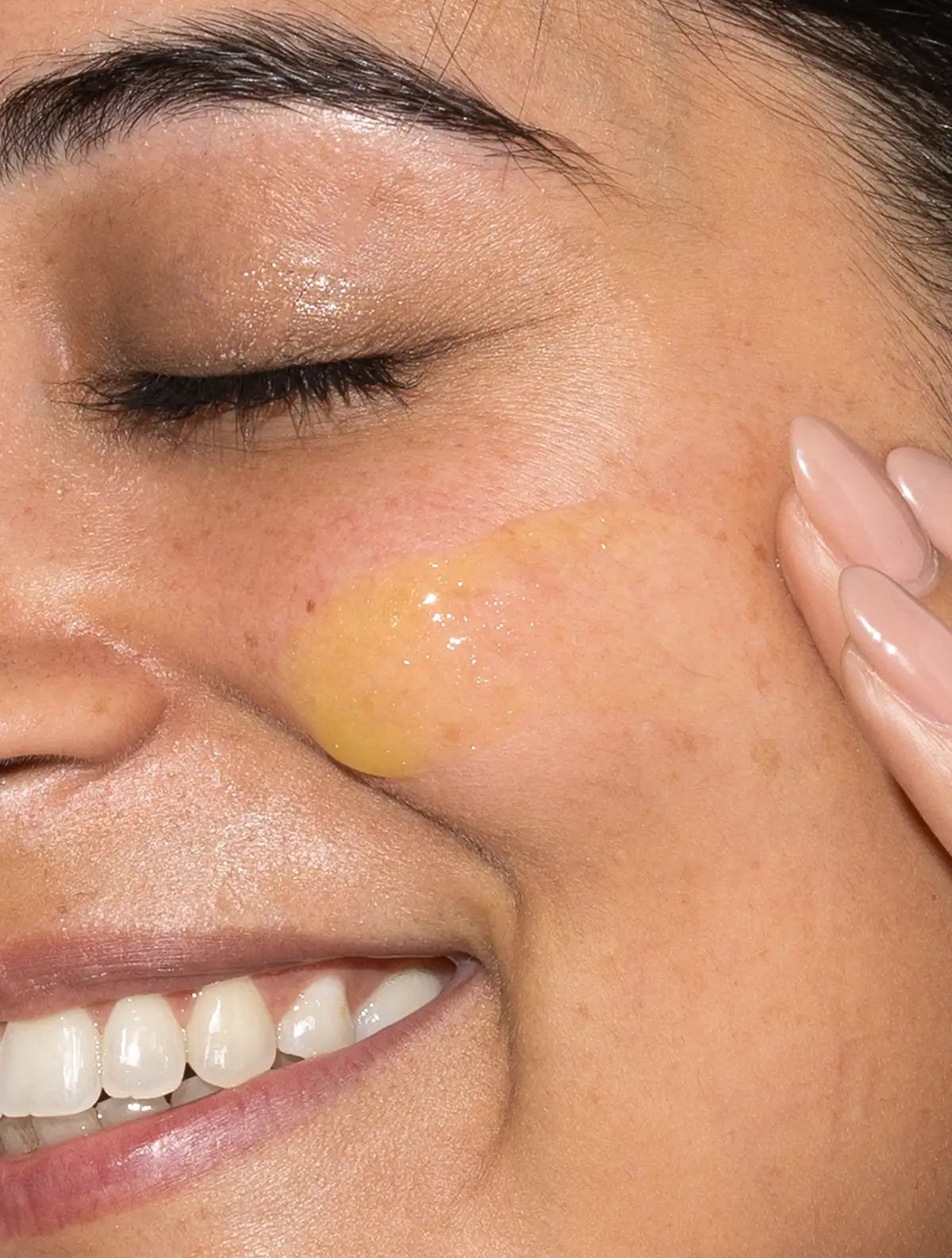 woman applying skincare retinol serum to her face