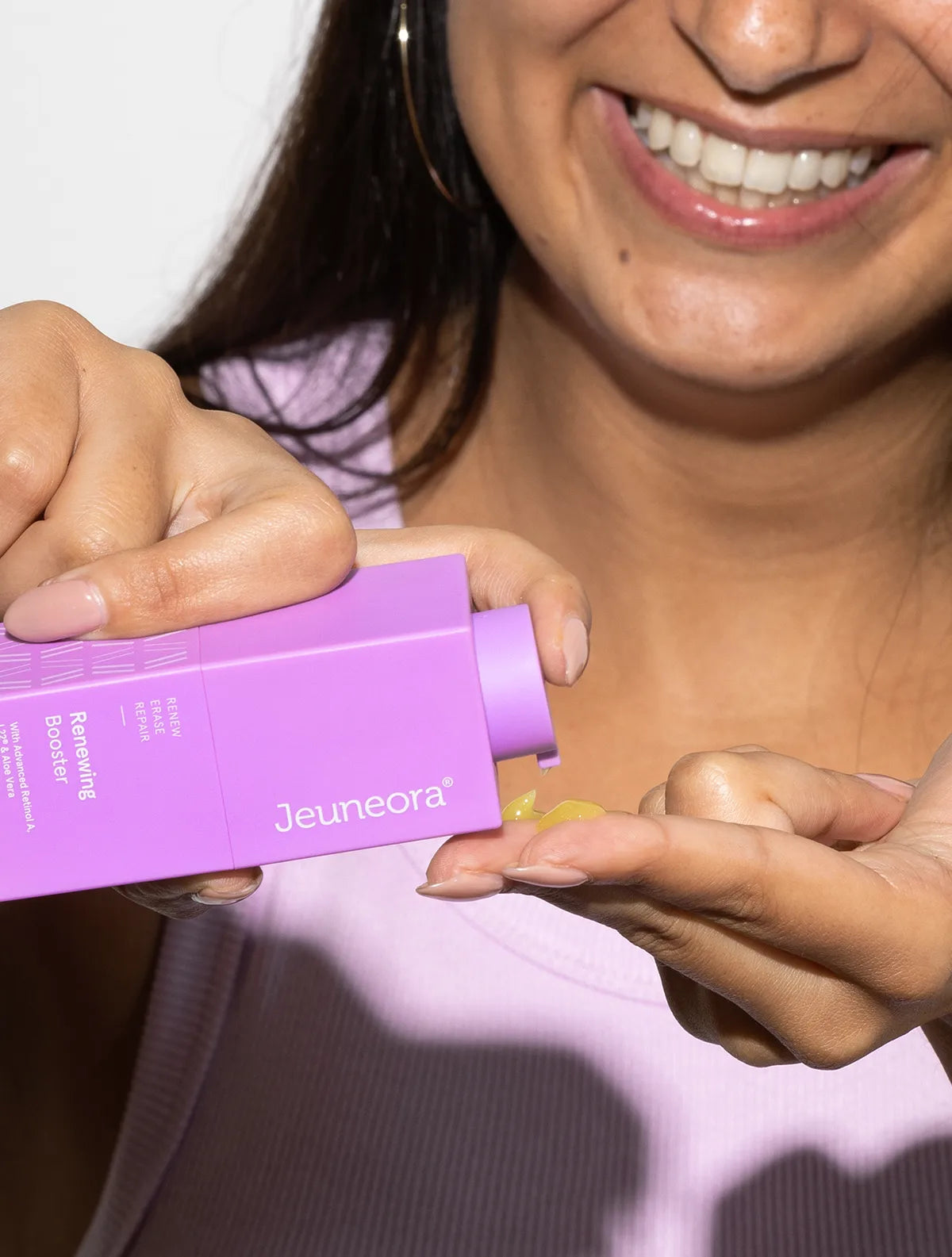 women pumping out retinol serum onto her hands