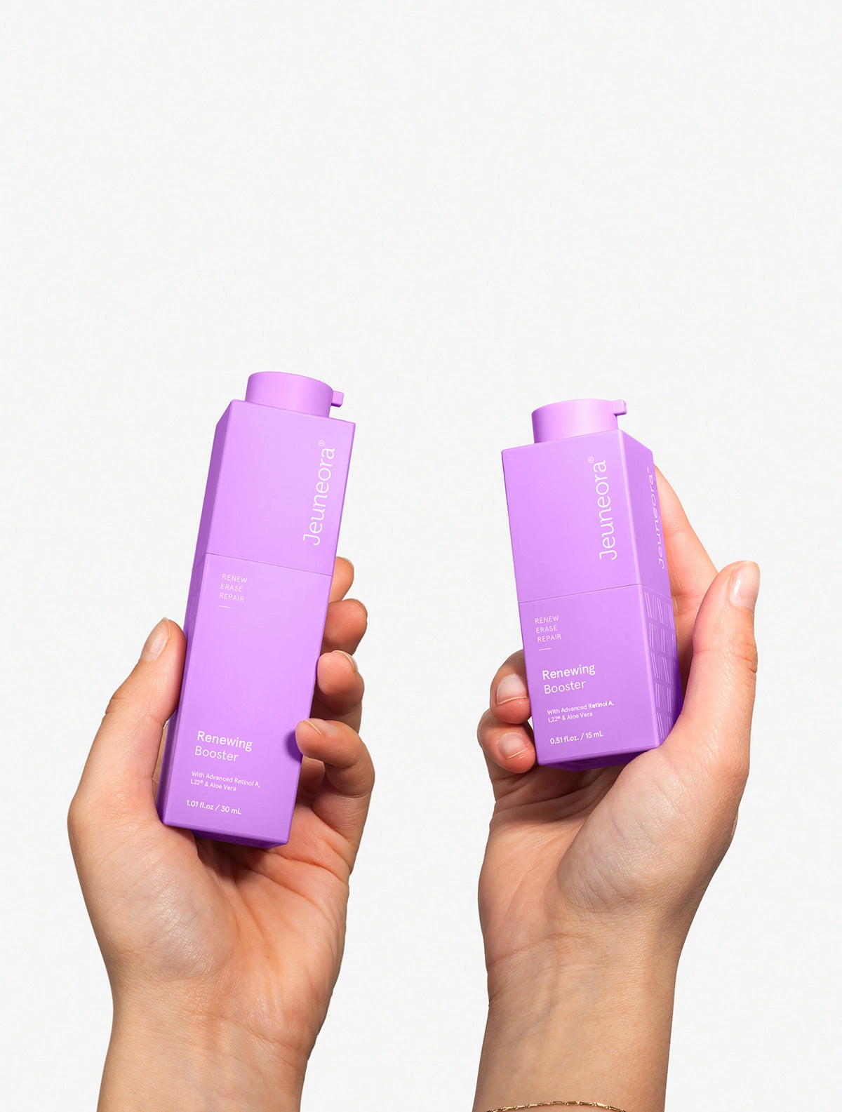 hands holding up two sizes of Jeuneora retinol face serum
