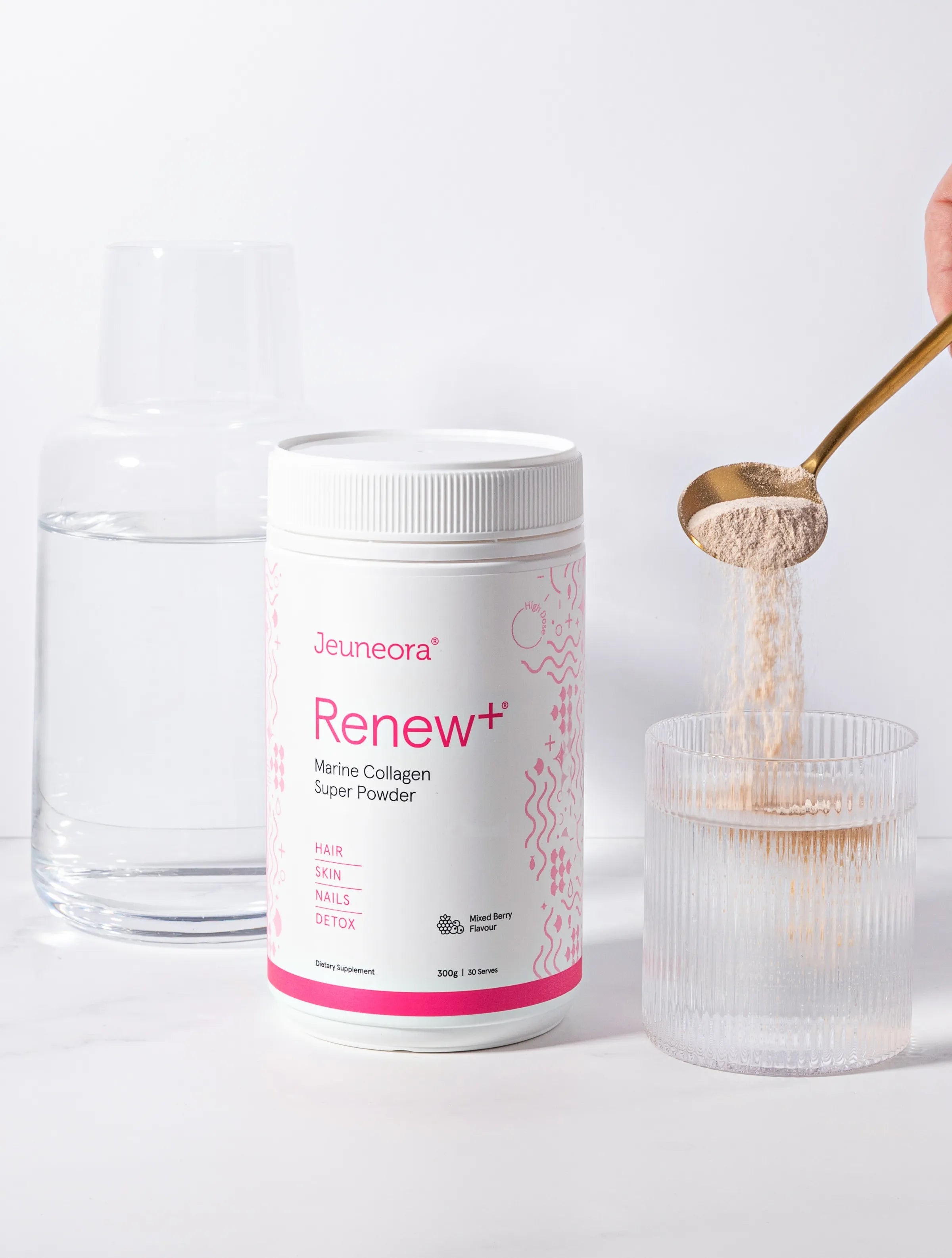 spoon of collagen powder pouring into glass of water
